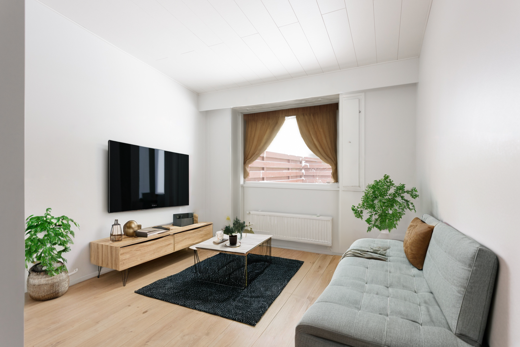 The open-plan room staged with a sofa and living-room furniture.