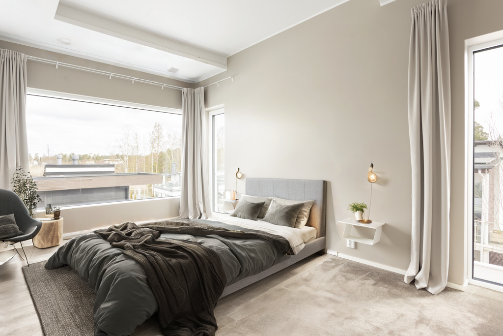 The carpeted room staged as a bedroom.